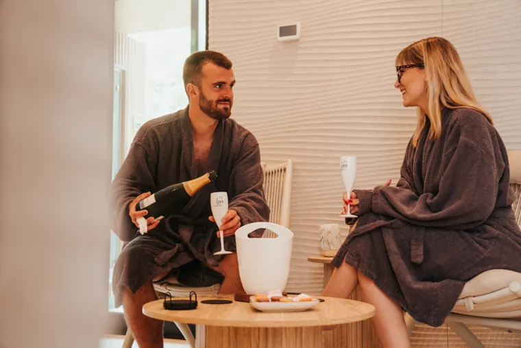 Couple in robes with champagne at Spa Elite